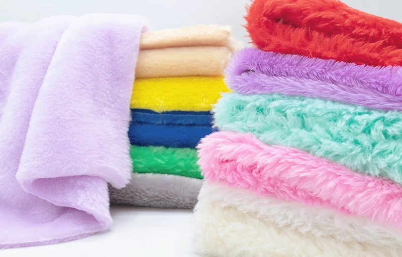 Detailed close-up of premium faux rabbit fur fabric showing dense and silky synthetic pile