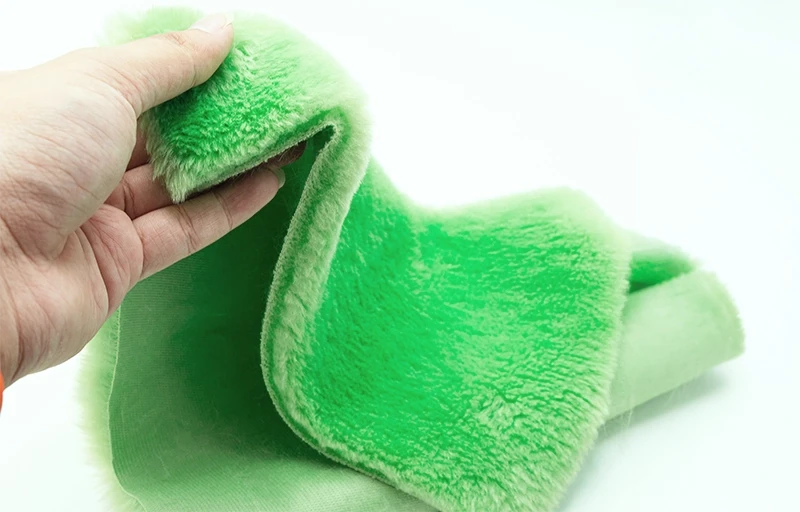 Close-up of dense, soft faux rabbit fur fibers produced from sustainable recycled polyester (rPET).