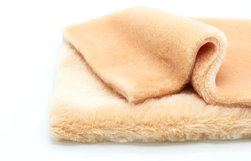 Three women presenting a wide range of faux rabbit fur products: luxury throw blankets, beanies, gloves, plush toys, and premium pet beds.